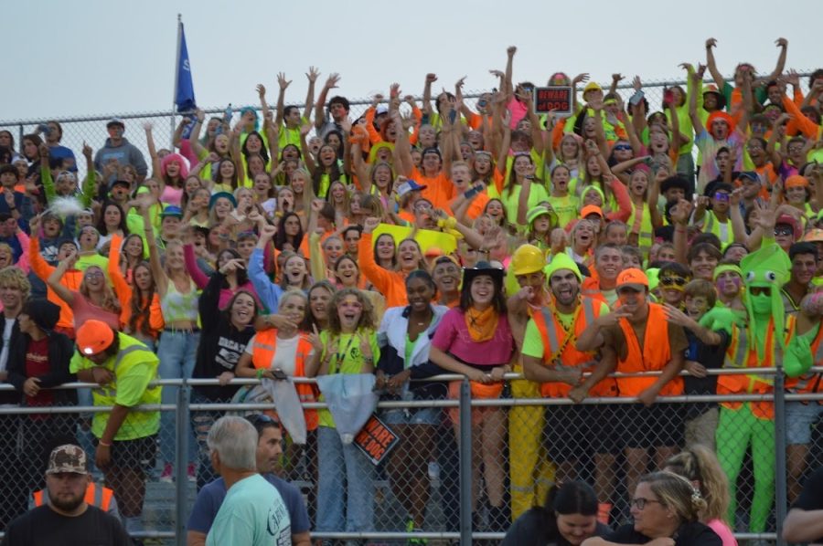 Students cheer during neon theme game