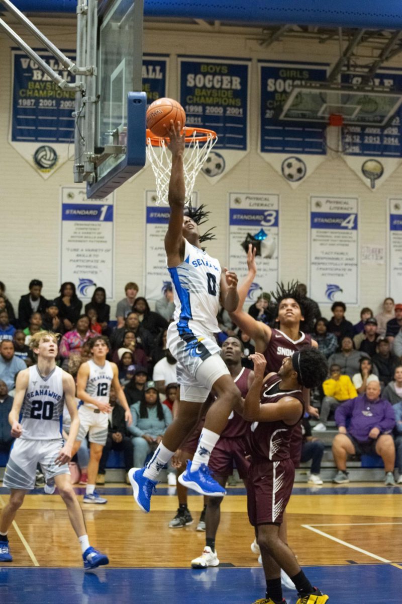 Davin Chandler drives to the hoop over two Snow Hill High School defenders during a Jan. 27 home game. Chandler, a junior, scored his 1,000th career point this season on Feb. 20. 