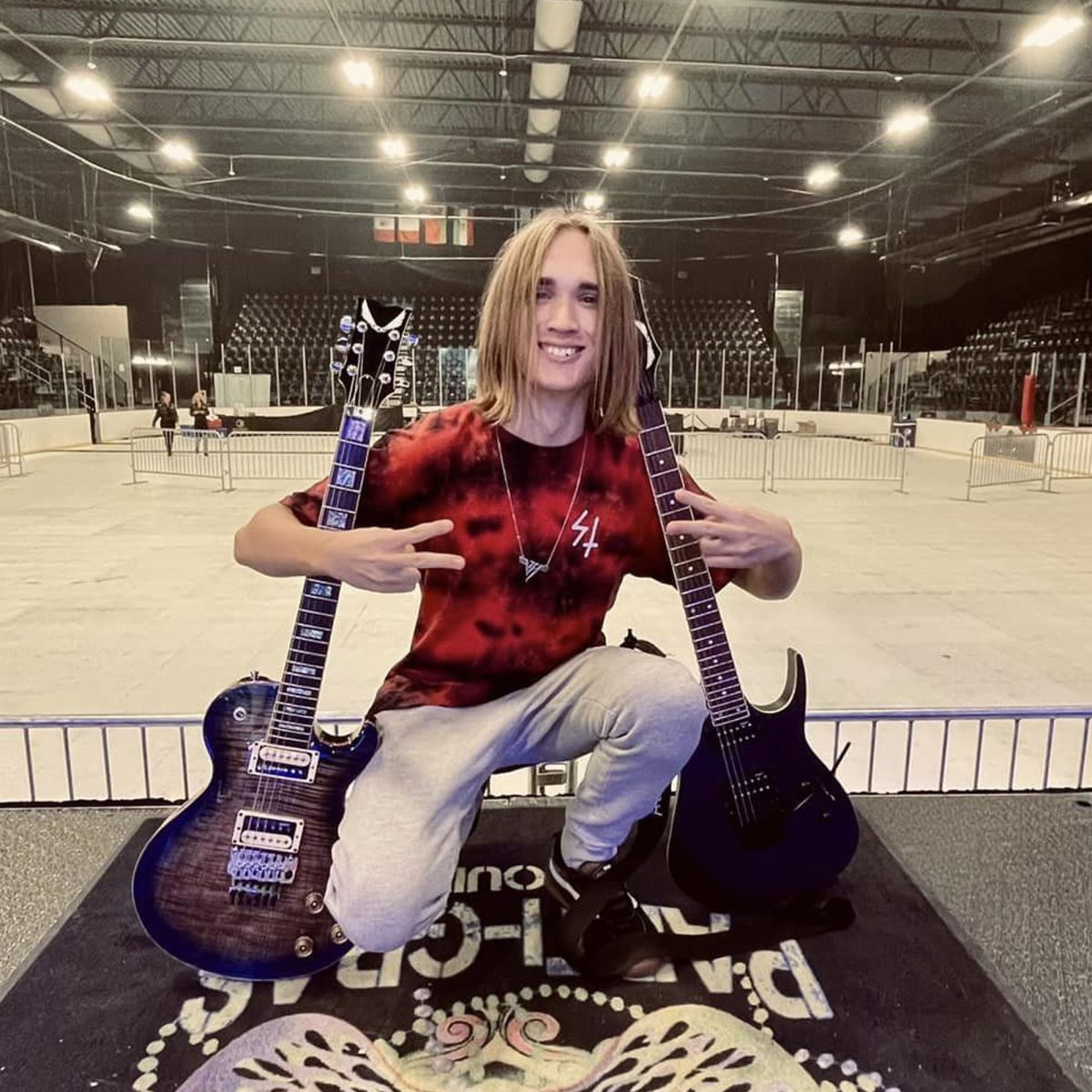 Teenage guitar virtuoso Gavin Brink poses with his instruments at a venue.